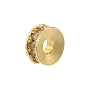 Macro detail of 18K gold plated rondelle spacer bead with purple crystals for DIY jewelry
