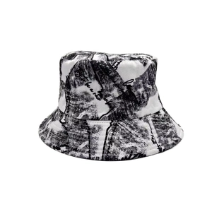 Detail of street style bucket hat featuring black and white ink graffiti and script patterns