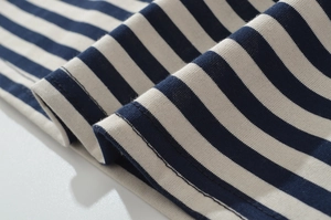 Close-up of blue and white striped knit fabric showing soft texture and fine stitching