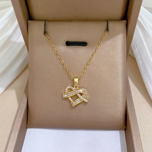 Luxurious gold heart pendant necklace set with sparkling zircons on velvet box