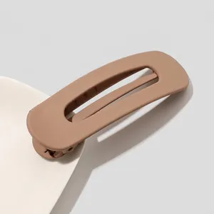 Detail view of khaki matte rectangular hair clip showing hollow design and texture