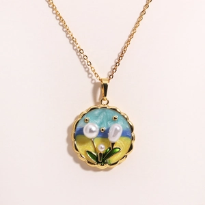 Detail of oil painting style flower pendant with natural freshwater pearls and gold chain