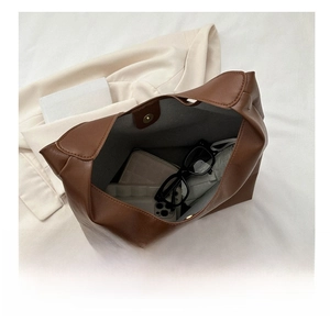 Top view of brown leather tote bag interior showing large capacity for essentials