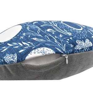 Detail of baby nursing pillow cover showing blue floral fabric and hidden zipper closure