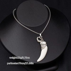 Close-up of elephant head necklace with white tusk on black mannequin, 70cm chain