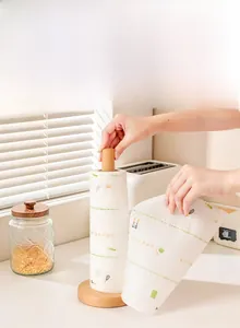 Vertical wooden kitchen paper towel holder with thick round base and natural wood texture