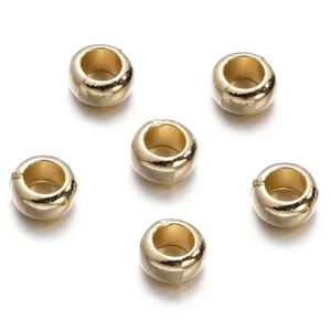 Detailed view of six polished gold CCB round spacer beads for DIY jewelry making