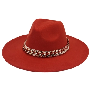 Close-up of wide brim red wool fedora hat featuring a chunky gold acrylic chain band