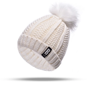 White winter knitted hat with a faux fur pompom decoration on top in 45-degree view