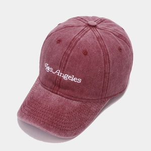 Detail of white Los Angeles embroidery on a vintage burgundy washed cotton baseball cap