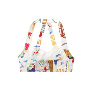 Detail of colorful fruit and floral prints on white cotton fabric with smocked back
