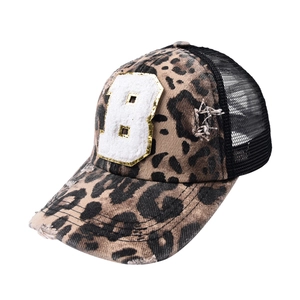 Detail of leopard print baseball cap with number 8 towel embroidery and gold sequins