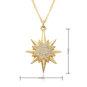 Macro view of gold North Star pendant with white zircon stones and size 29mm by 23mm