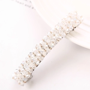 Detail of silver hair clip featuring intricate rows of faceted crystal beads and clusters