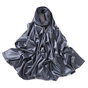 Detailed view of the smooth grey satin scarf showing its glossy silk-like texture and folds