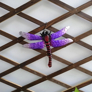 Detail view of purple gradient metal dragonfly wall decor with hand-painted iron texture