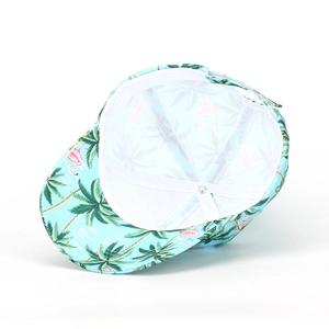 Detail view of tropical flamingo and coconut tree print on a canvas baseball cap lining