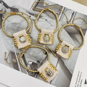 Set of four religious fabric cord bracelets with gold beads and saint pendants