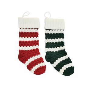 Large knitted Christmas stockings in red and green stripes with white cuffs and hanging loops