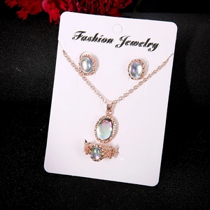 Rose gold jewelry set with oval iridescent stones including necklace, ring, and earrings
