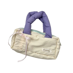 Large soft cream stationery bag with purple padded handle and pink ribbon bow