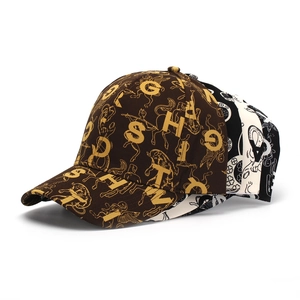 Close-up of three baseball caps featuring retro letter prints and mythological totems