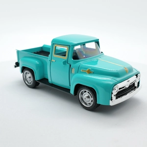 Macro side view of vintage teal alloy pickup truck toy with silver and gold accents