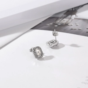Macro detail of silver rectangular earrings featuring clear zircon stone and micro-pavé setting