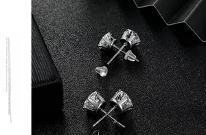 Macro detail of six-prong titanium steel stud earrings with cubic zirconia and butterfly backs