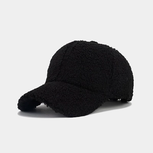 Detailed close-up of thick black faux shearling fleece texture on a winter baseball cap