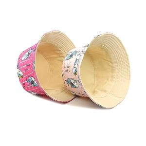 Flat lay of cotton shark print sun hats in pink stripes and light patterns