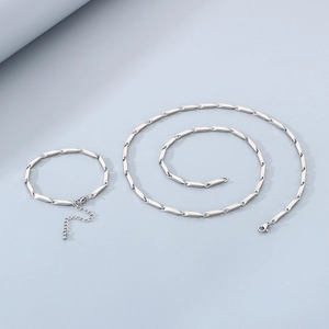 Detailed view of silver stainless steel bamboo chain necklace and bracelet set with lobster clasp
