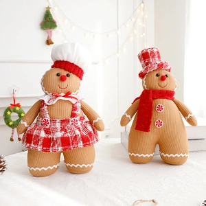 Close-up of plush gingerbread doll set with chef hat and red plaid festive accessories
