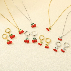 Fashionable stainless steel cherry necklace and earring set in gold and silver finishes