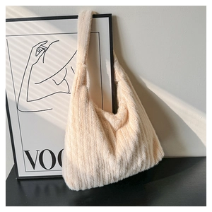 Detail of beige faux fur shoulder bag with vertical texture and soft plush material