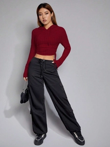 Burgundy cropped long sleeve hoodie and black cargo pants set on professional model