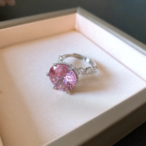 Macro view of an adjustable silver ring with a large round pink zircon centerpiece