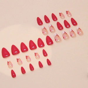 Red almond press-on nails set with floral patterns and French tips on a warm beige background