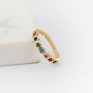 Minimalist gold adjustable ring with colorful star-shaped stones on white marble