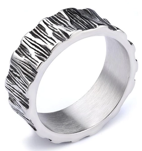 Close-up of wide silver ring with rustic bark texture and oxidized black details