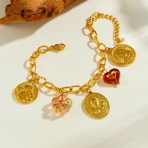Vintage gold layered bracelet with relief coins, floral charms and amber heart pendant