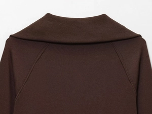 Detail of dark brown knit jacket showing high-quality lapel collar and raglan sleeve stitching