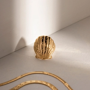 Close-up of 18K gold plated shell ring with realistic texture and polished finish