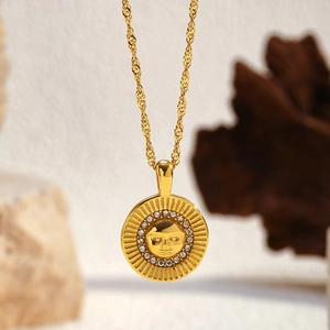 Macro shot of gold sun god medallion necklace with sparkling zircon details
