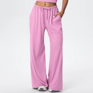 Detail of high-waist elastic drawstring waistband and side pockets on pink wide-leg pants