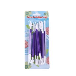 Detail view of 8-piece purple and white fondant sculpting tool set in clear packaging
