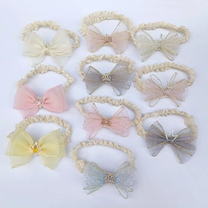 Set of 10 lace baby headbands with mesh bows and crown accents on white background