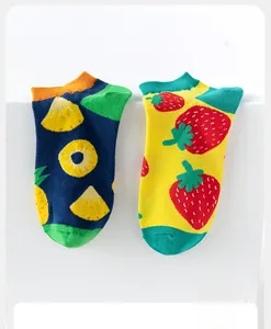 Close-up of cotton socks with pineapple and strawberry patterns in high-quality knit