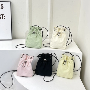 Minimalist drawstring canvas bucket bags in multiple colors with adjustable shoulder straps
