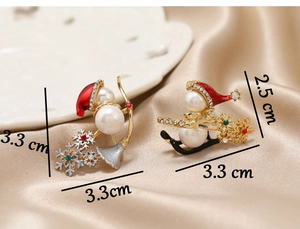 Detailed view of two Christmas snowman brooches with size specs on satin and porcelain